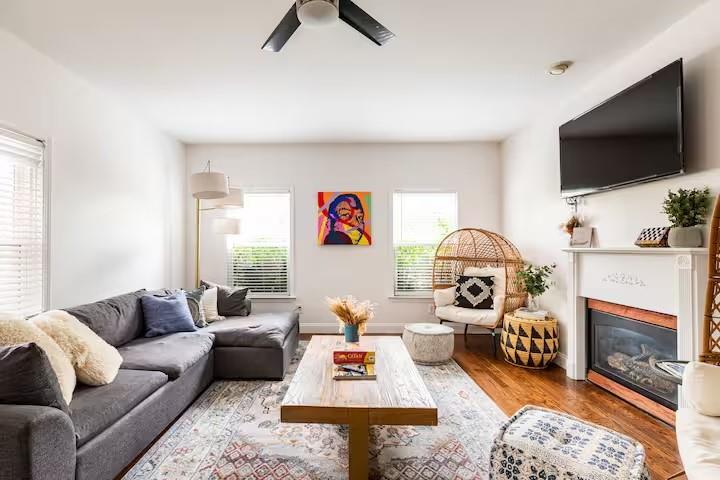 673 Windsor Street Southwest Atlanta, GA 30310 - Photo 9 of 29 a living room with furniture a flat screen tv and a fireplace