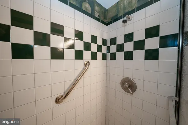 a bathroom with a black and white checkered floor