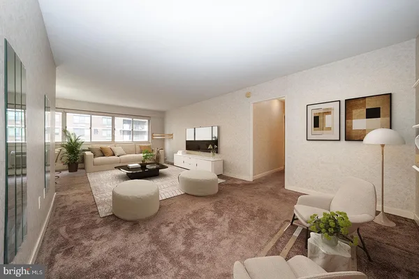 a living room with furniture and a potted plant