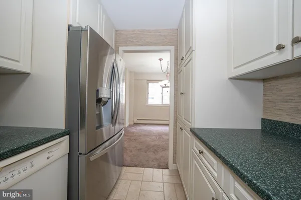 a kitchen with a refrigerator and countertop