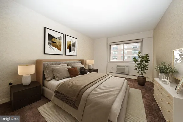 a bedroom with a large bed and a potted plant