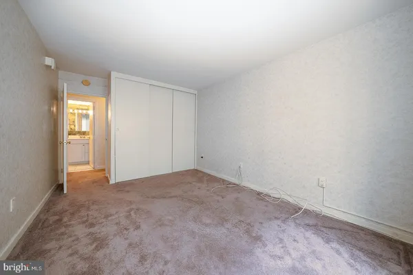 a view of an empty room and a window