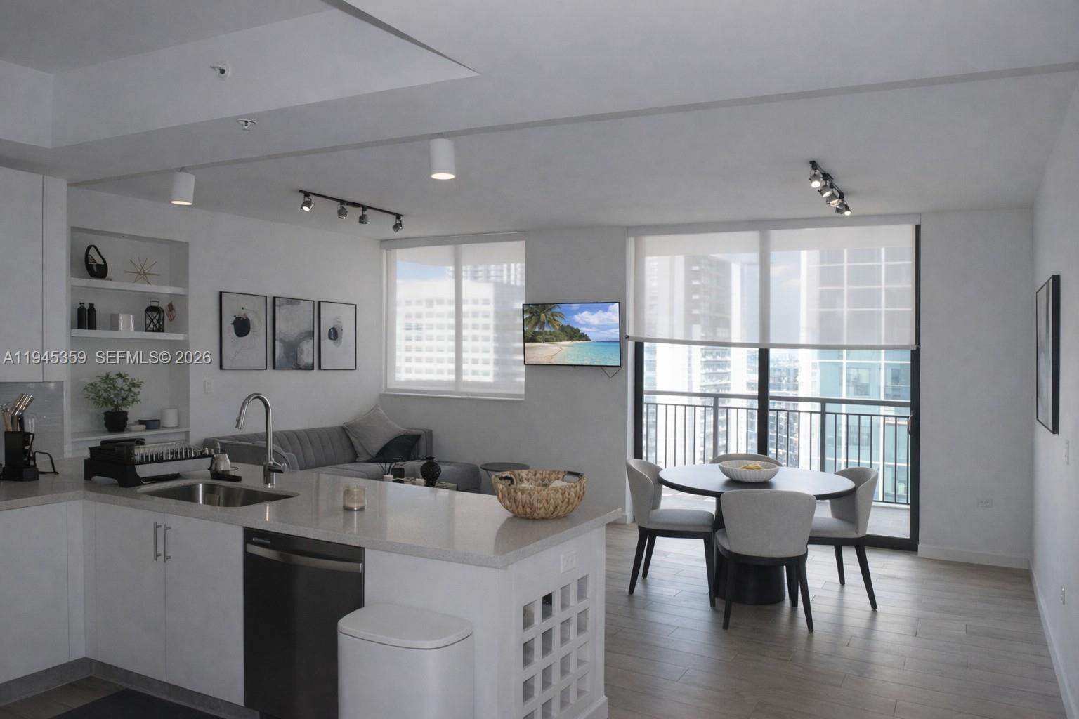 999 Southwest 1st Avenue, Unit 2214 Miami, FL 33130 - Photo 1 of 36 a view of a a dining room with furniture window and wooden floor