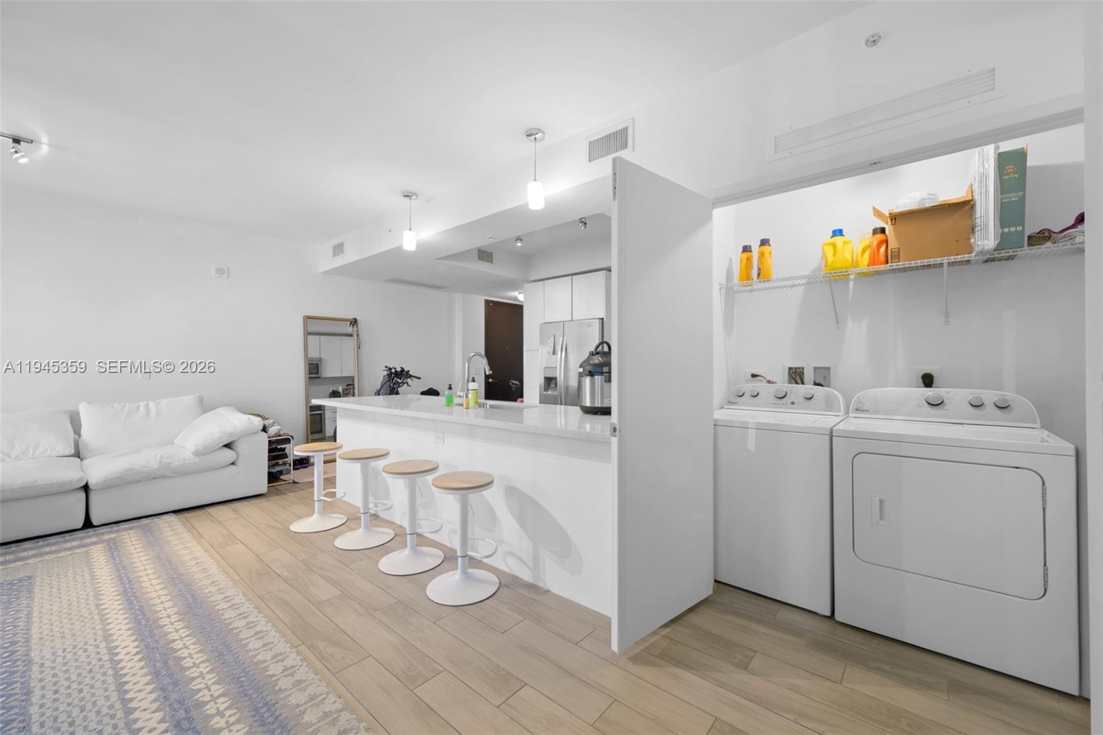 999 Southwest 1st Avenue, Unit 2214 Miami, FL 33130 - Photo 11 of 35 a living room with furniture and a wooden floor