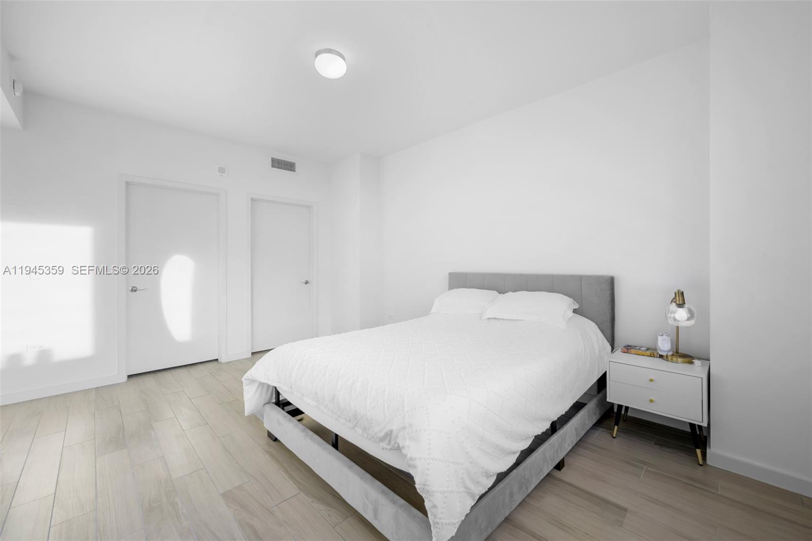 999 Southwest 1st Avenue, Unit 2214 Miami, FL 33130 - Photo 12 of 36 a bedroom with a bed and a window