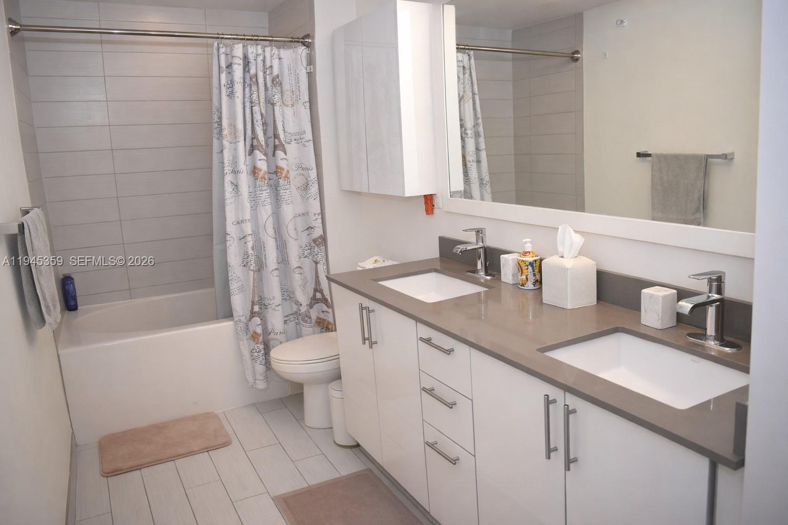 999 Southwest 1st Avenue, Unit 2214 Miami, FL 33130 - Photo 13 of 36 a bathroom with a double vanity sink toilet and shower