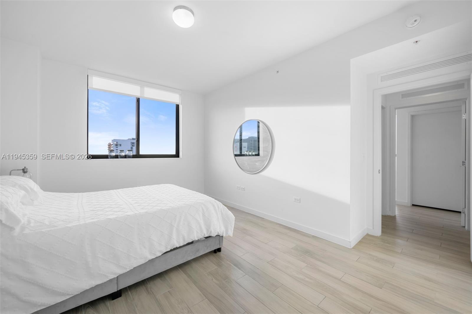 999 Southwest 1st Avenue, Unit 2214 Miami, FL 33130 - Photo 13 of 35 a bedroom with a bed and a painting on the wall