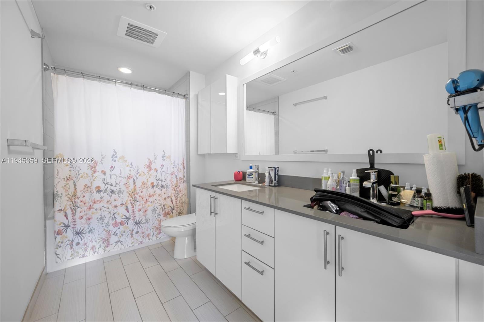 999 Southwest 1st Avenue, Unit 2214 Miami, FL 33130 - Photo 15 of 35 a kitchen with a sink and cabinets