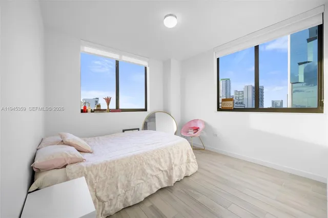 a bedroom with a bed and a painting on the wall