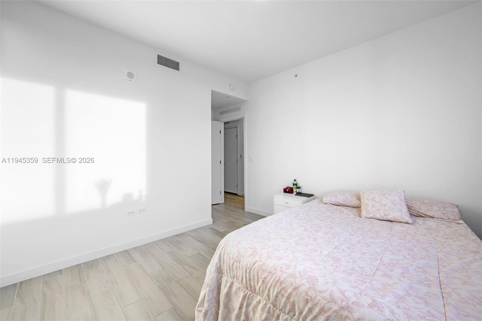 999 Southwest 1st Avenue, Unit 2214 Miami, FL 33130 - Photo 18 of 35 a bedroom with a bed and a window