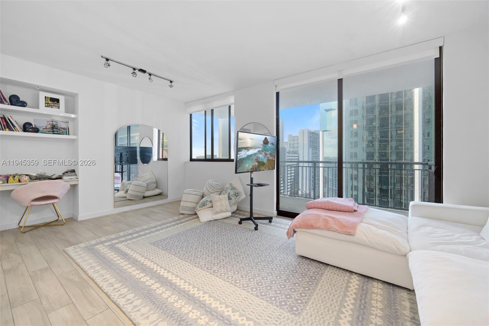 999 Southwest 1st Avenue, Unit 2214 Miami, FL 33130 - Photo 2 of 35 a spacious bedroom with a bed and glass floor