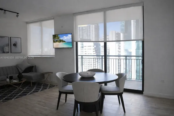 a view of a dining room with furniture and wooden floor