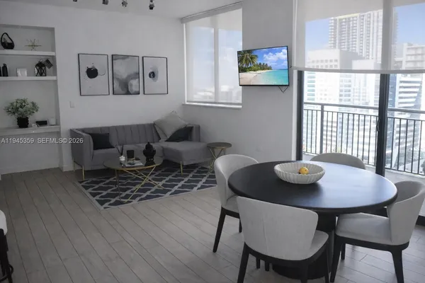 a view of a dining room with furniture and wooden floor