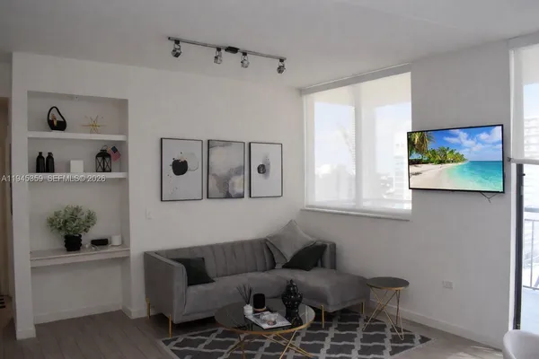 a living room with furniture and wooden floor