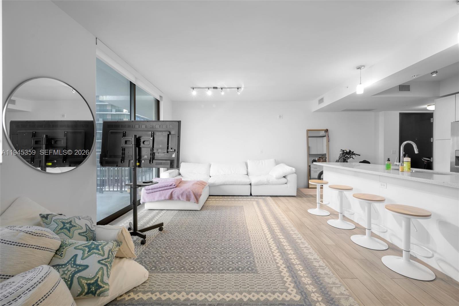 999 Southwest 1st Avenue, Unit 2214 Miami, FL 33130 - Photo 5 of 35 a living room with furniture and a fireplace