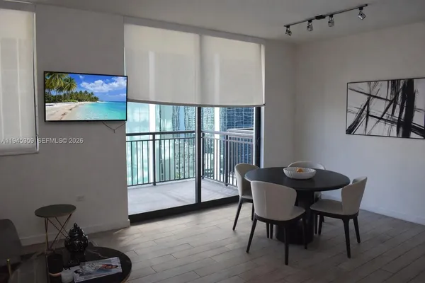 a view of a room with furniture and wooden floor