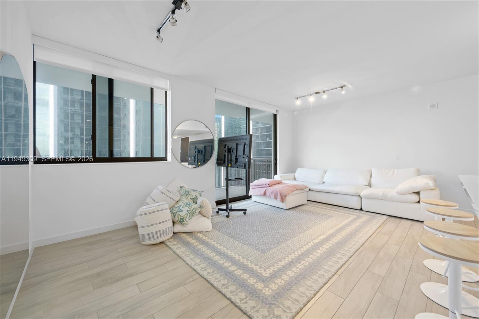 999 Southwest 1st Avenue, Unit 2214 Miami, FL 33130 - Photo 7 of 35 a living room with furniture and wooden floor