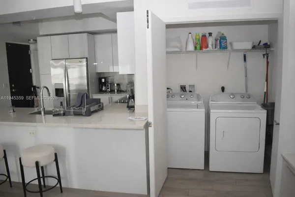 a room with a sink storage and utility