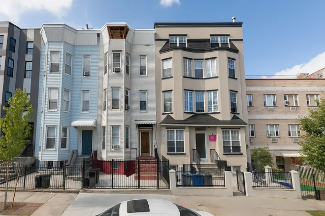 a front view of a building with retail shops
