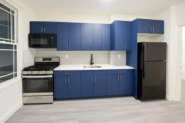 a kitchen with wooden cabinets and stainless steel appliances