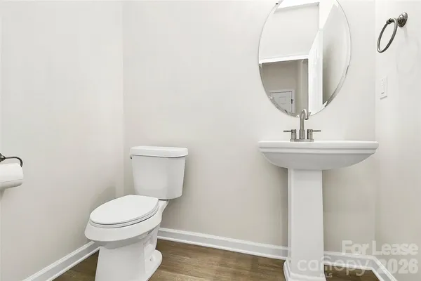 a bathroom with a sink a toilet and mirror