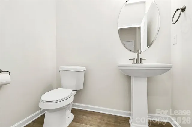 a bathroom with a sink a toilet and mirror