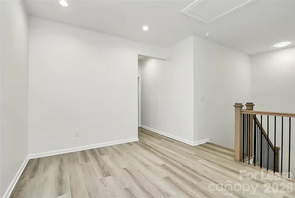 a view of hallway with wooden floor