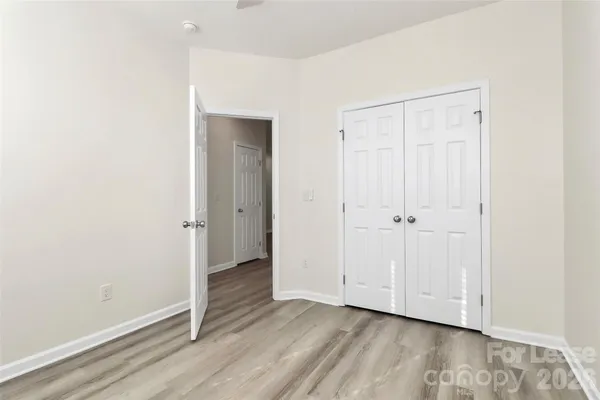 an empty room with wooden floor