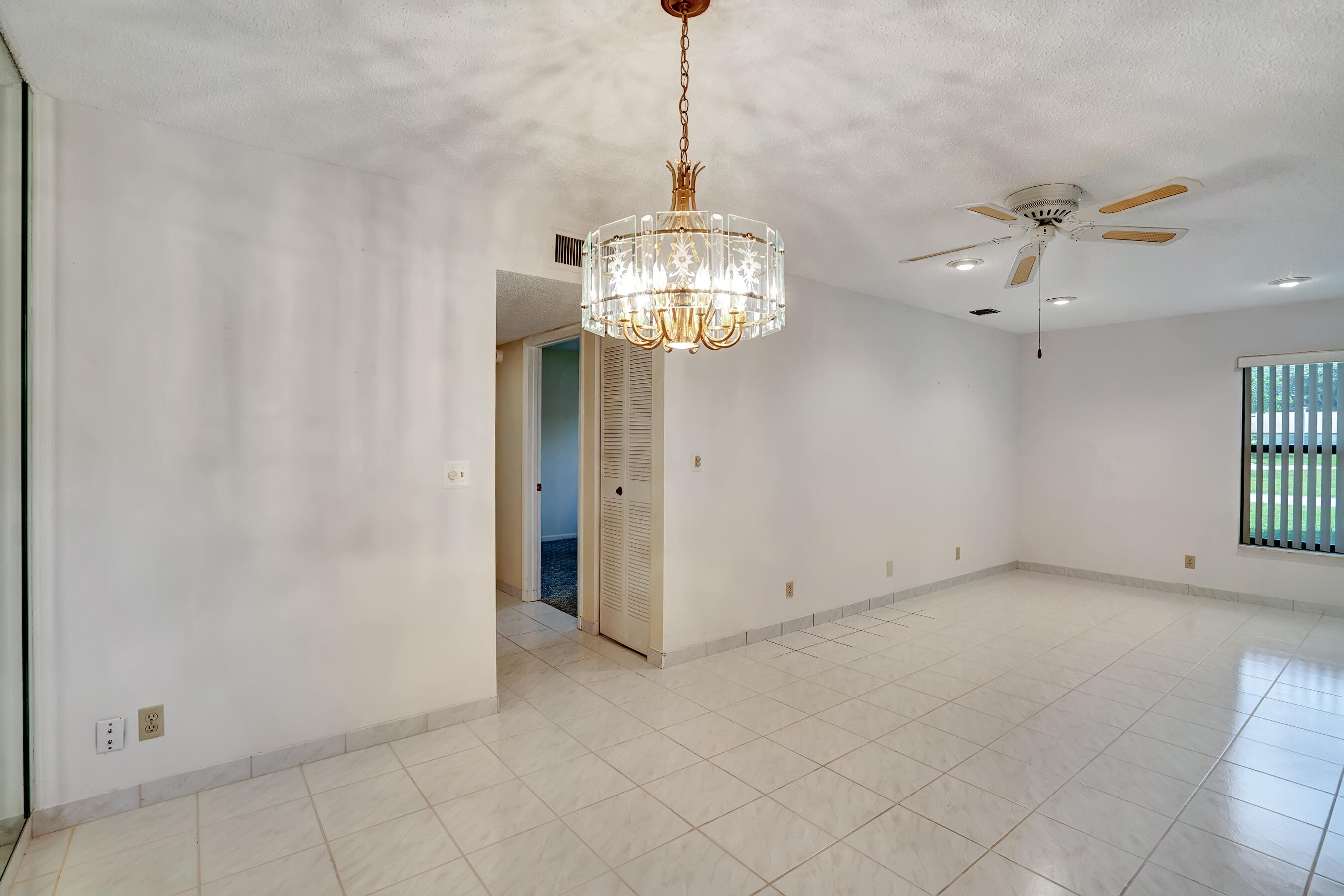 14100 Nesting Way, Unit D Delray Beach, FL 33484 - Photo 12 of 31 a view of a chandelier fan and entryway