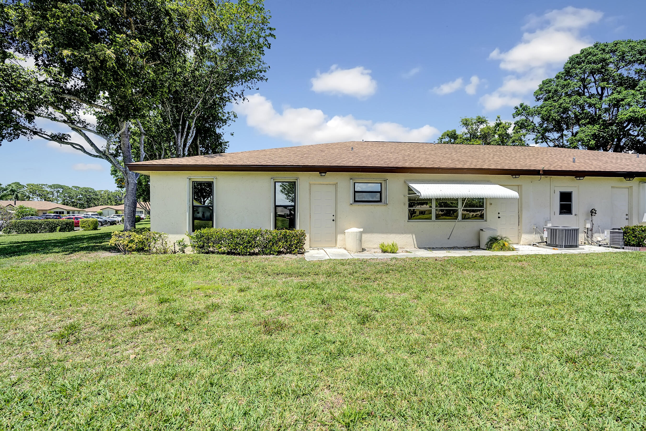 14100 Nesting Way, Unit D Delray Beach, FL 33484 - Photo 5 of 31 a front view of house with yard and green space