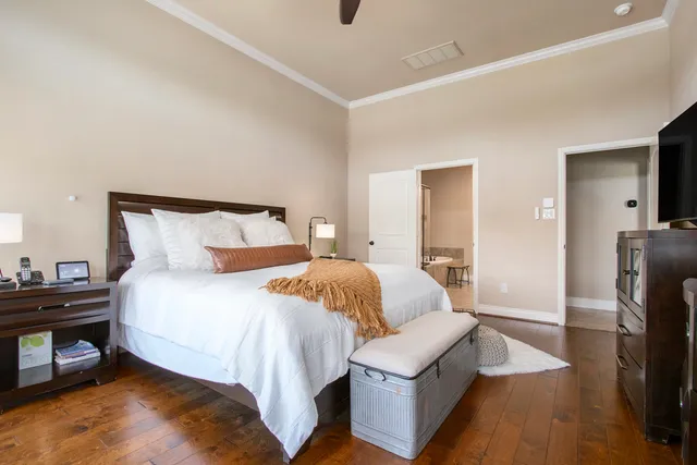 a bedroom with a bed and a tv