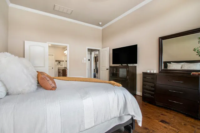 a bedroom with a bed and a flat screen tv