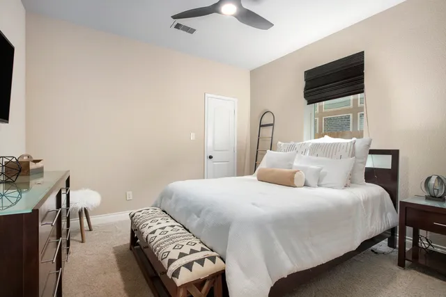 a bedroom with a bed and a chair