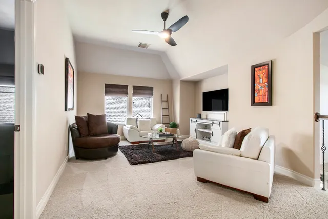 a living room with furniture ceiling fan and a rug