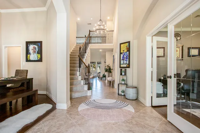 a view of a hallway with workspace and a living room