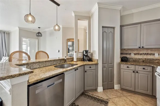 a kitchen with granite countertop a sink and cabinets