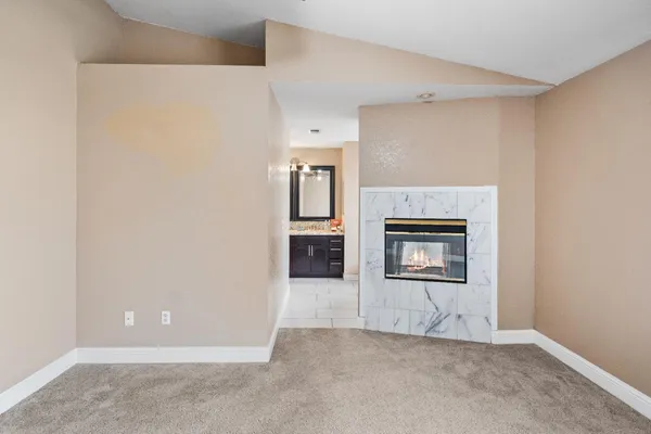 a bathroom with a granite countertop sink and a bathtub