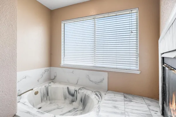a white toilet sitting next to a shower