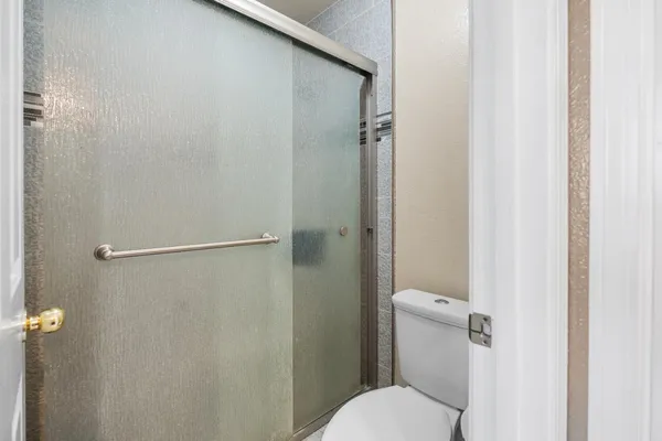 an empty room with a fan and a fan