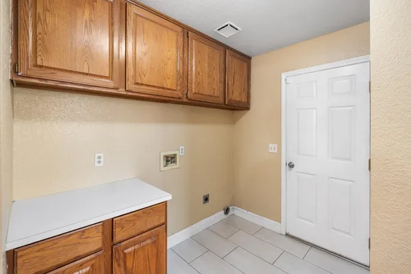 a view of a patio with table and chairs potted plants