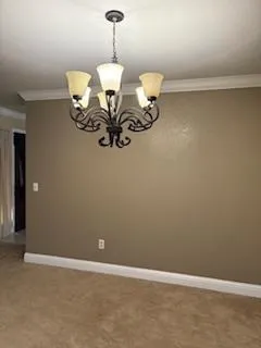 a view of room with chandelier fan and wooden floor