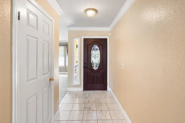 a view of a hallway with wooden floor and a bathroom