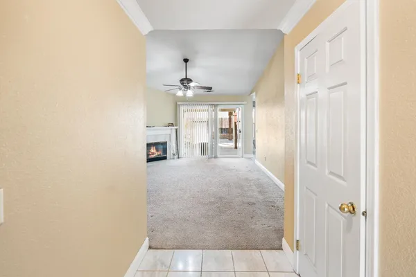 a view of livingroom with flat screen tv and fan