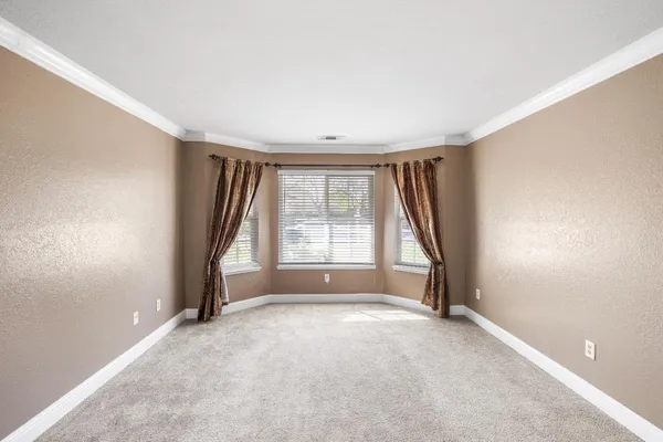 a view of a big room with closet and windows
