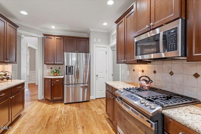 a dining room with furniture a chandelier and wooden floor