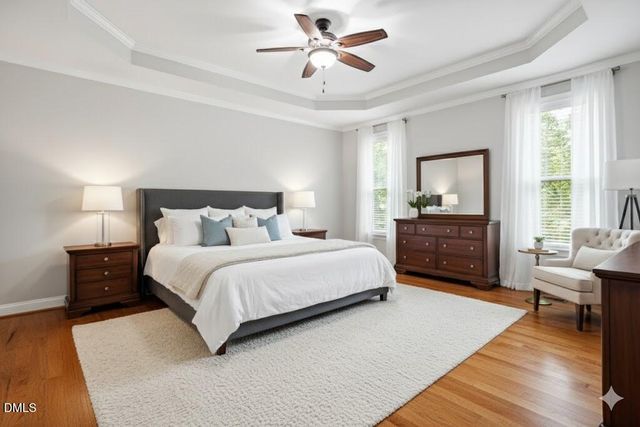 a bedroom with furniture and a wooden floor