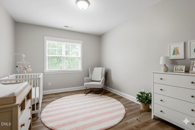 a swimming pool with lawn chairs and plants