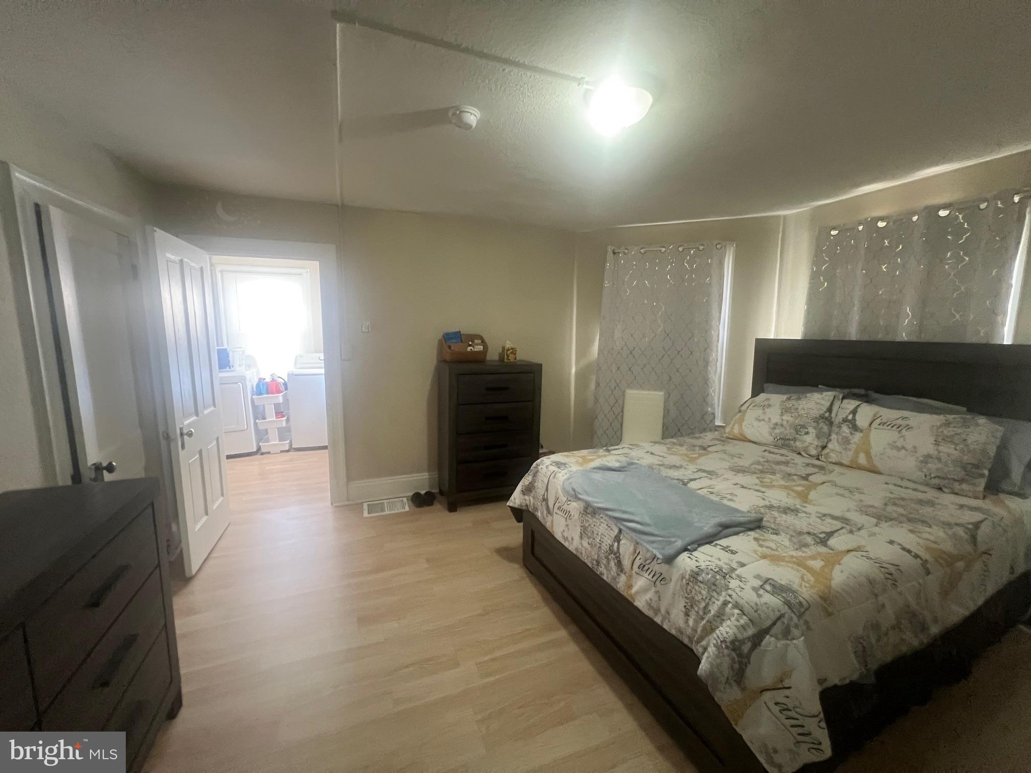 810 North Division Street Salisbury, MD 21801 - Photo 11 of 38 a spacious bedroom with a bed and a refrigerator