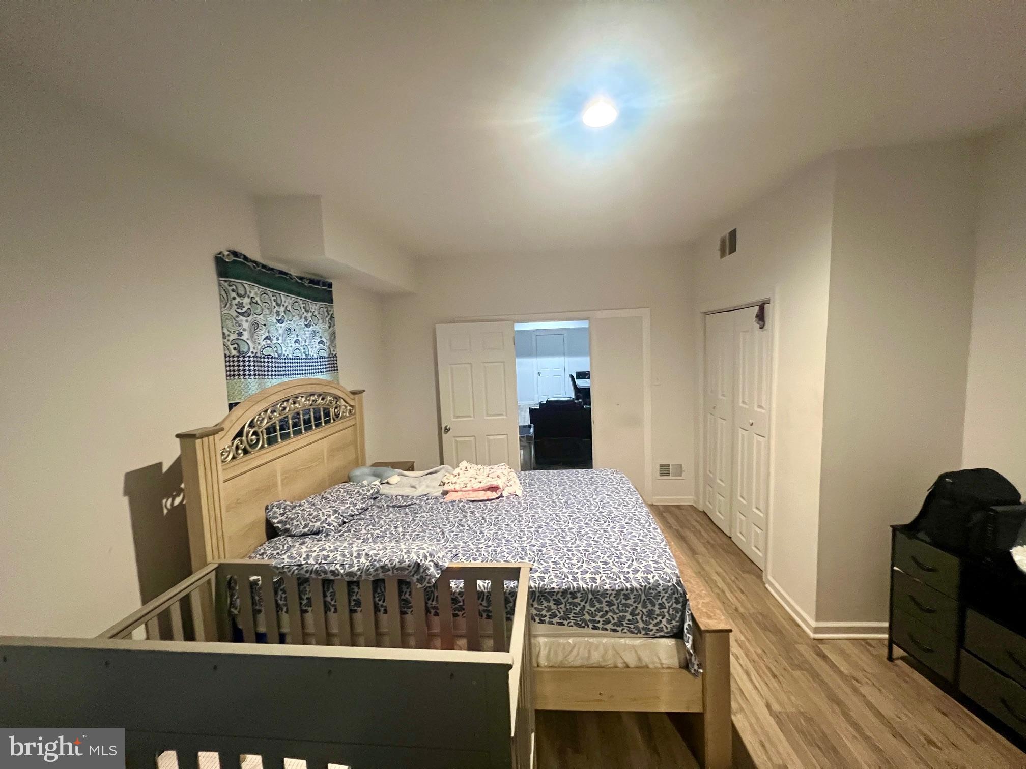 810 North Division Street Salisbury, MD 21801 - Photo 22 of 38 a bedroom with a bed and wooden floor