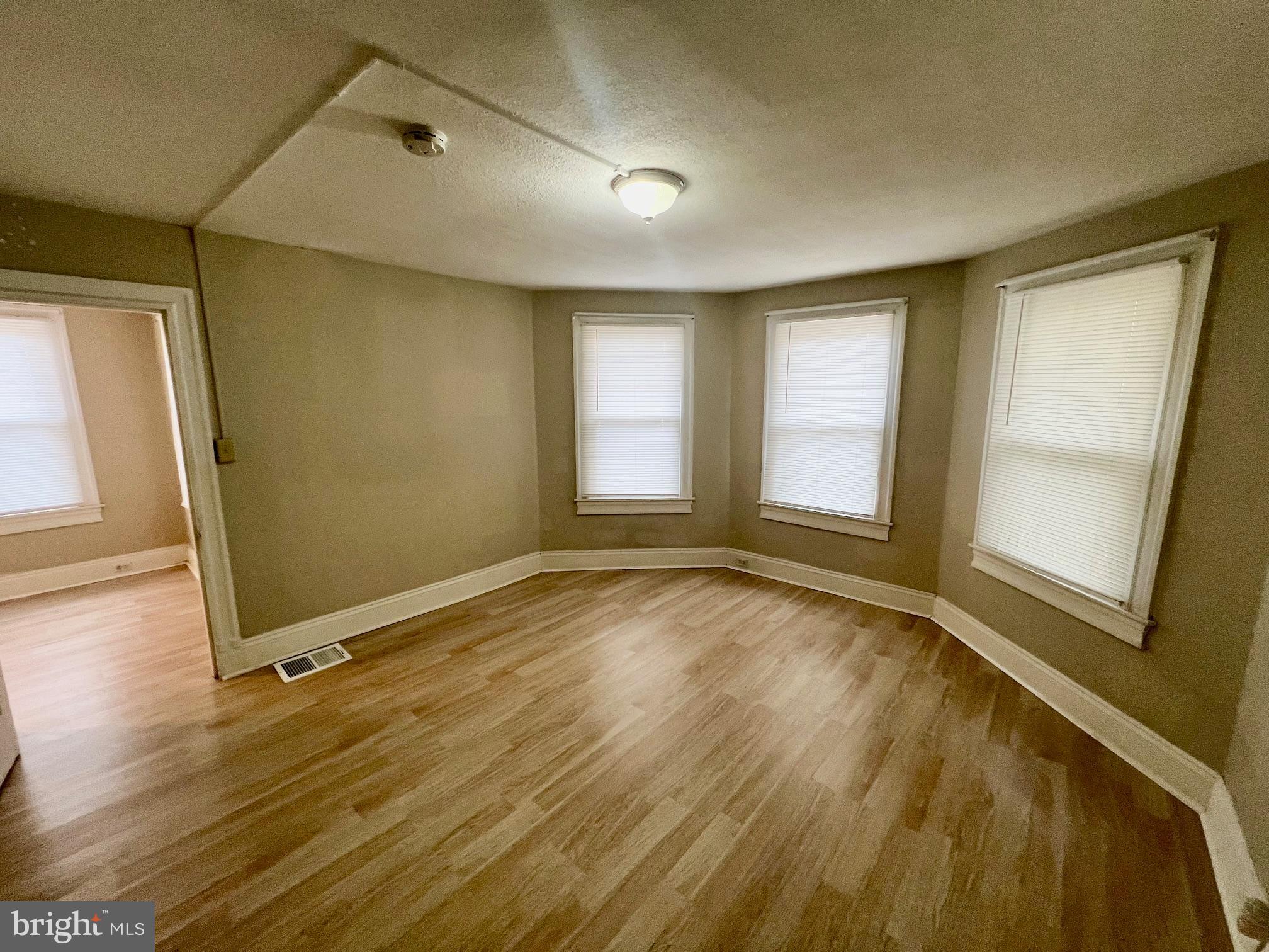 810 North Division Street Salisbury, MD 21801 - Photo 30 of 38 a view of an empty room with a window and wooden floor